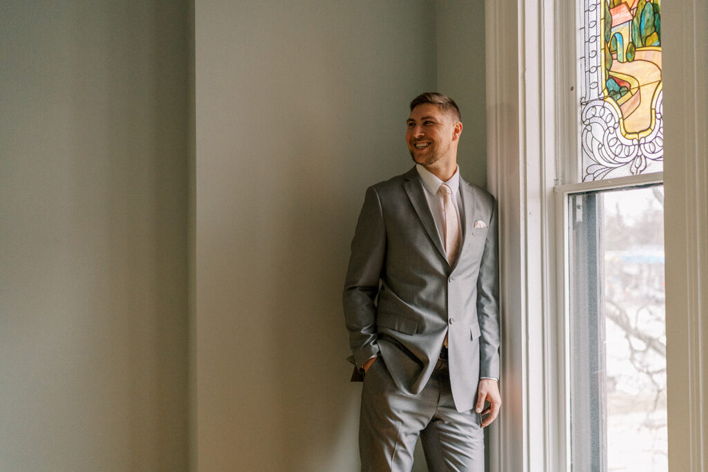 The groom looking back at his bride at The Deland House. 